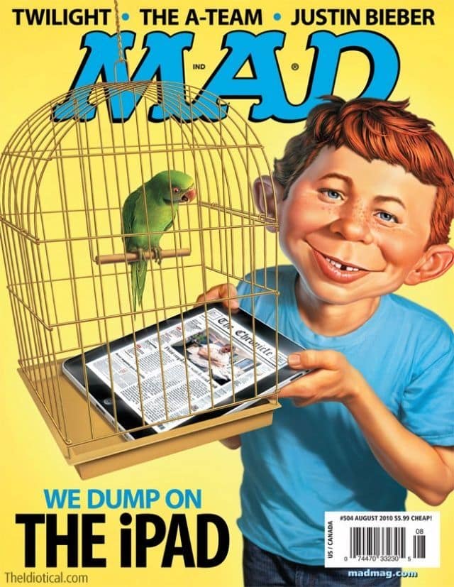 A vintage mad magazine cover from August 2010 featuring Alfred E. Neuman holding an iPad inside a birdcage as a makeshift liner. A green parrot perched above looks down ready to "dump" on the device, while the headline boldly screams: "WE DUMP ON THE iPAD."
