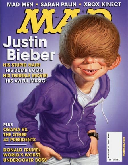 A vintage mad magazine cover from April 2011 taking aim at Justin Bieber. Alfred E. Neuman is caricatured with the singer's signature 2010s "swoop" hairstyle completely covering his eyes, under a series of hostile headlines mocking his "stupid hair" and "awful music."