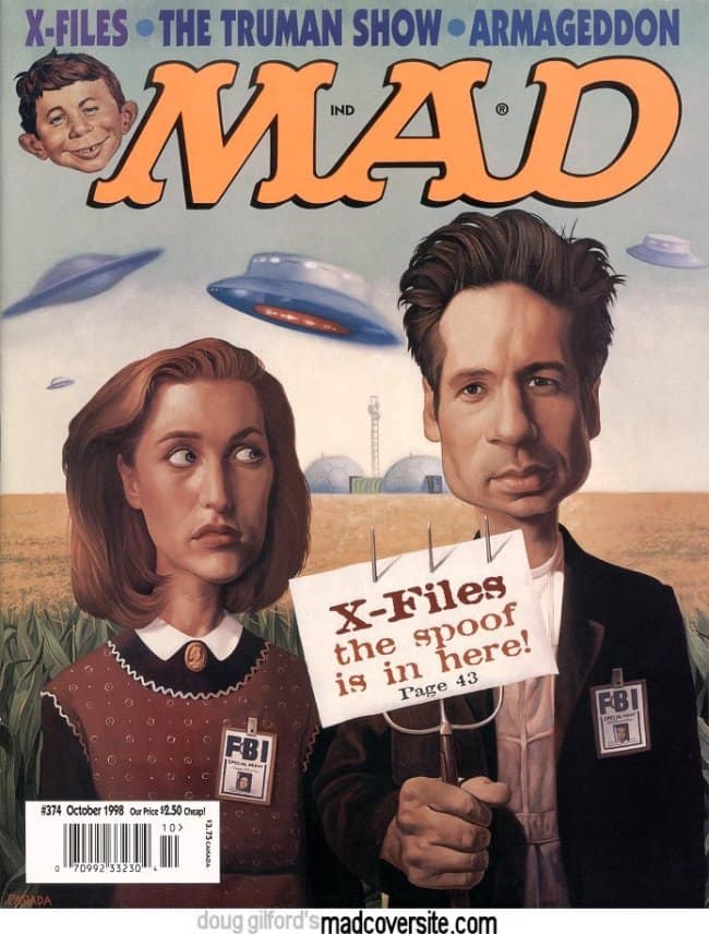 An eerie vintage mad magazine cover from October 1998 spoofing The X-Files. Caricatures of Mulder and Scully look suspiciously off-camera in a cornfield under UFOs, while Alfred E. Neuman’s severed head is perched on a pitchfork in Mulder's hand.