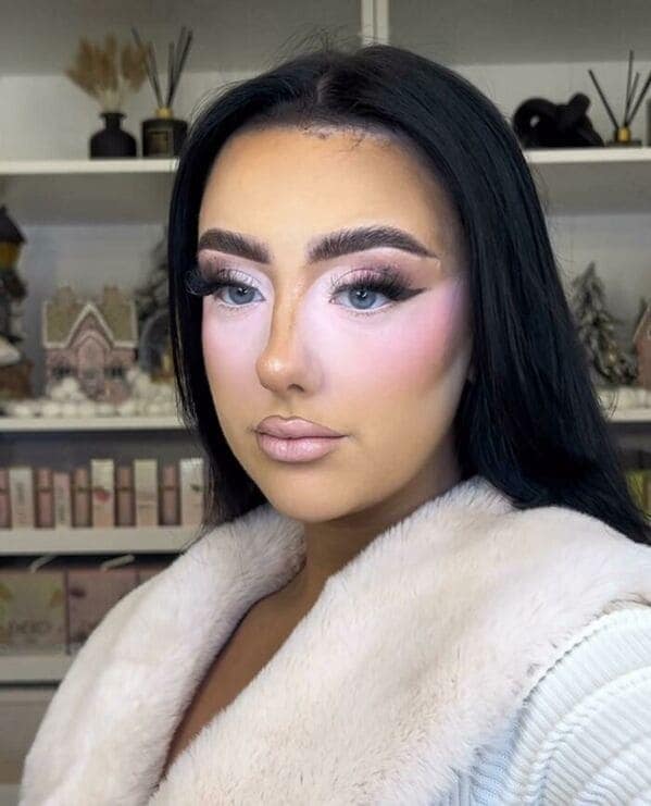 A classic "reverse raccoon" makeup fail where stark white unblended concealer creates a bright ring around the eyes and nose. This high-contrast look is set against foundation that is several shades too orange for the subject's neck.