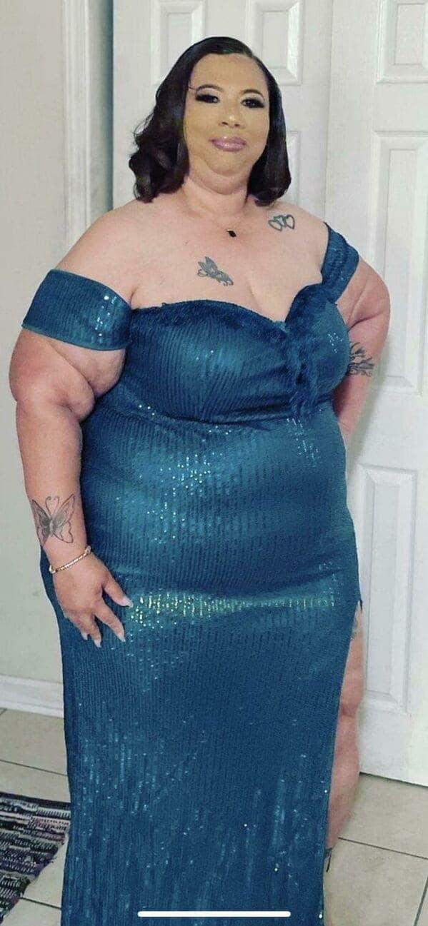 A full-body makeup fail where a woman in a teal sequined dress has facial foundation that is significantly lighter and more yellow than her actual skin tone, creating a disconnected "floating head" appearance against her neck and shoulders.