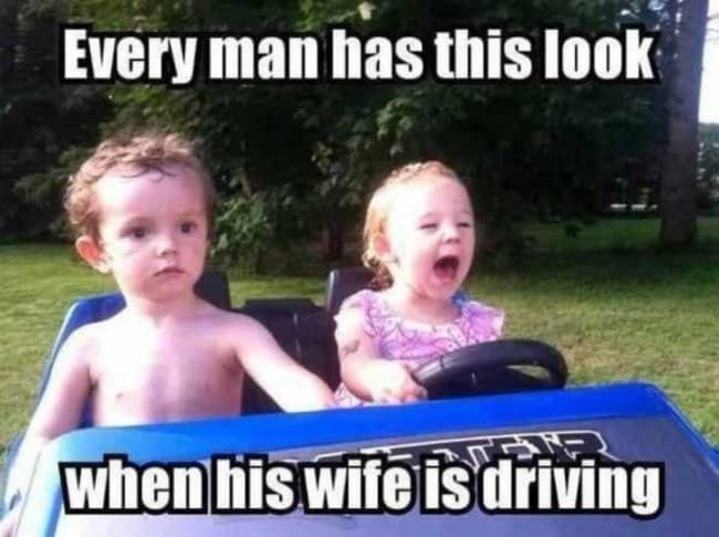 o toddlers in toy car with boy looking terrified while girl drives, captioned "every man with wife driving"