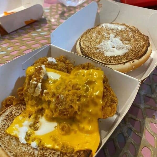 McDonald's chicken sandwich fail with cheese melted everywhere and top bun separated showing mess