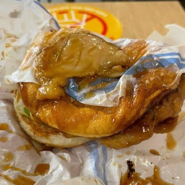 Messy McDonald's chicken sandwich fail with sauce everywhere and wrapper stuck to the chicken