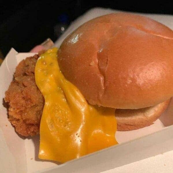 McDonald's chicken sandwich fail with cheese draping off patty and bun positioned off center