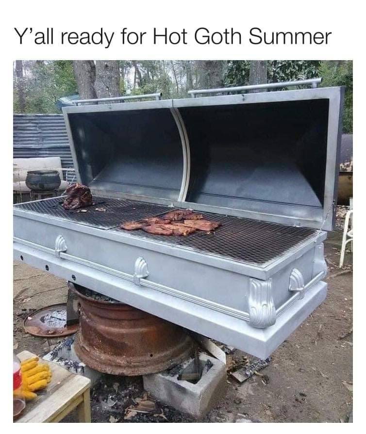 A metal coffin modified into a large outdoor barbecue grill, with the lid propped open to reveal ribs and meat cooking on metal grates. The text above the cursed image reads, "Y'all ready for Hot Goth Summer."