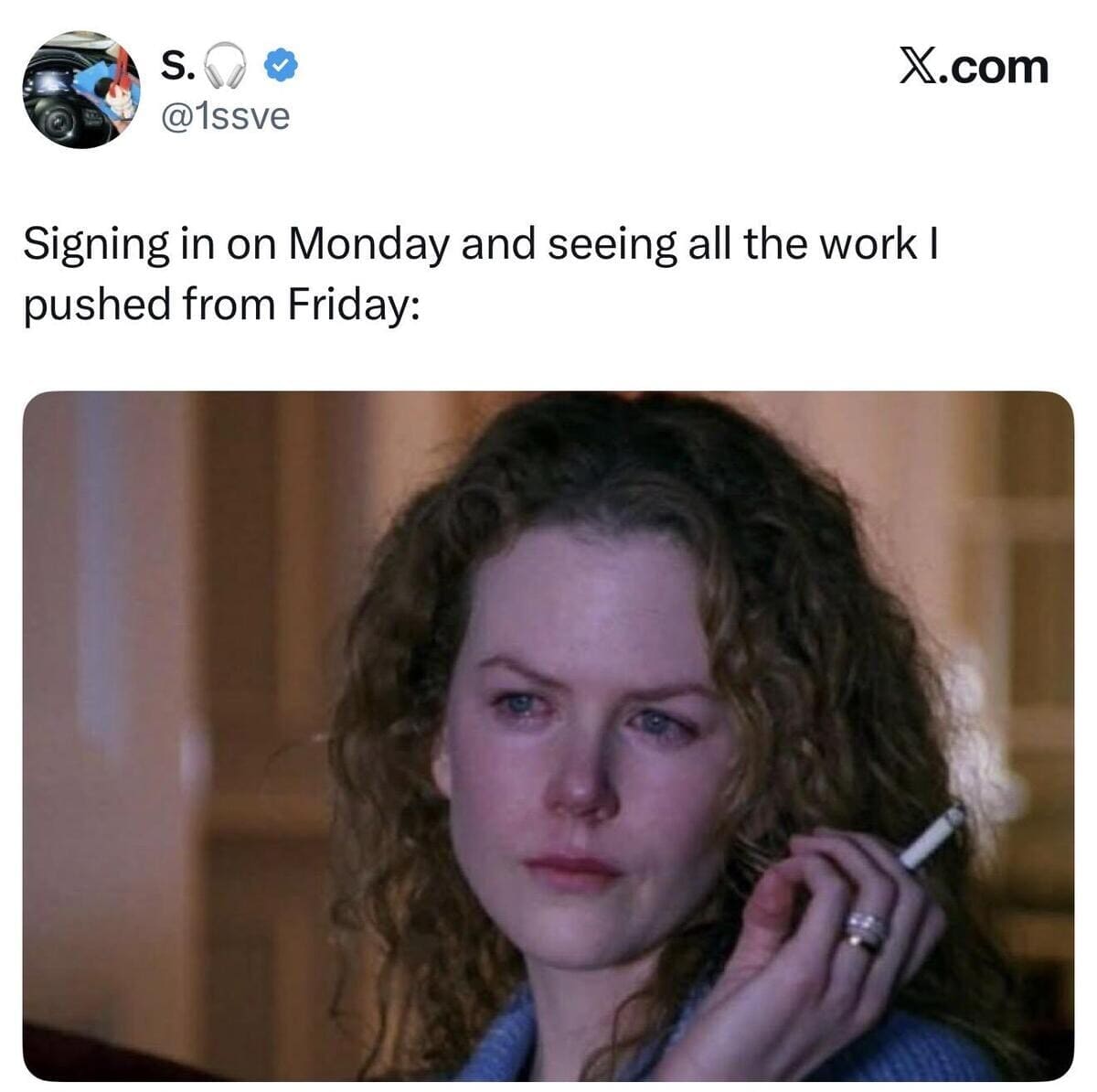 A relatable meme screenshot of a tweet about the dread of Monday morning. Below the text, a close-up from a movie shows a frizzy-haired Nicole Kidman looking deeply weary and tearful while holding a lit cigarette, representing the regret of ignoring work on Friday.