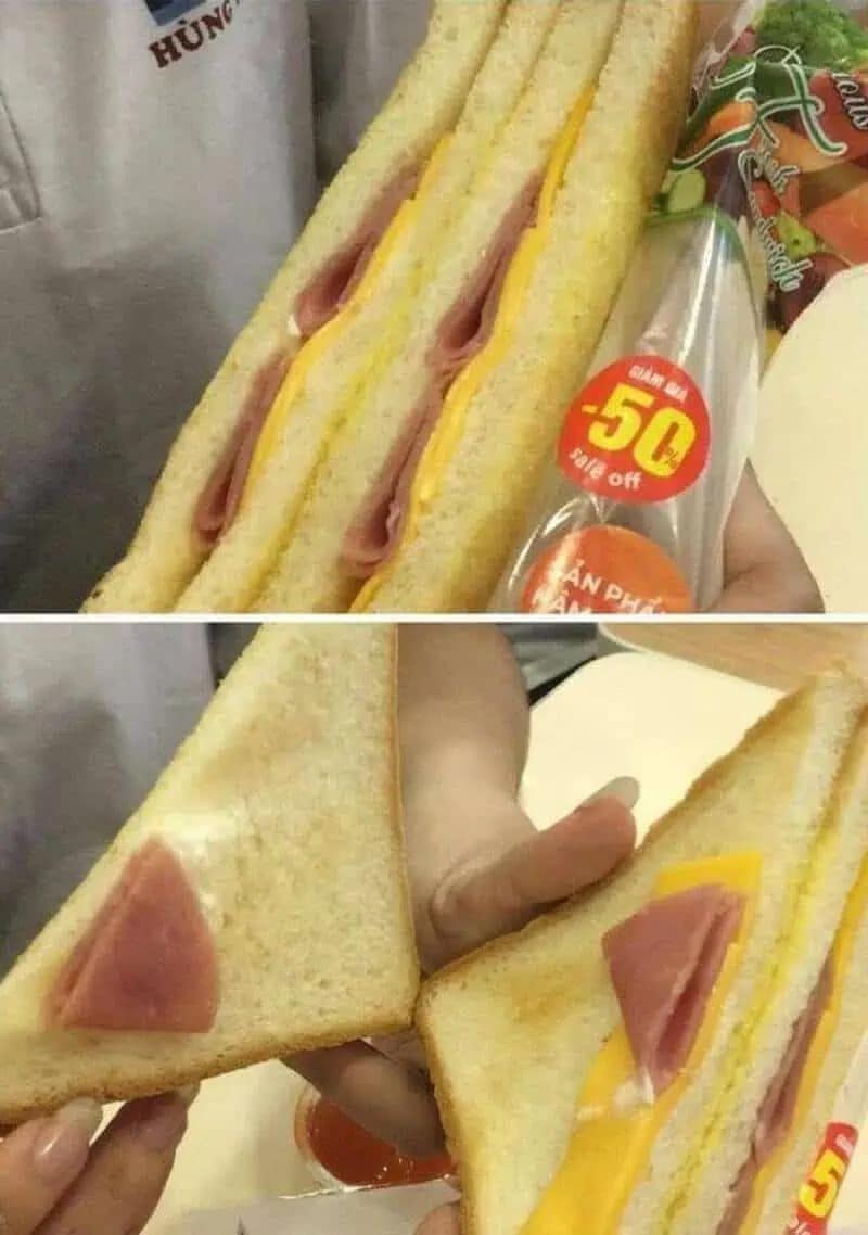 relatable "expectation vs. reality" funny meme showcasing a sandwich scam. The top photo shows a packaged sandwich looking stuffed with ham; the bottom photo reveals that once opened, the "ham" is just a tiny triangle folded and placed right at the edge of the bread to deceive the buyer.