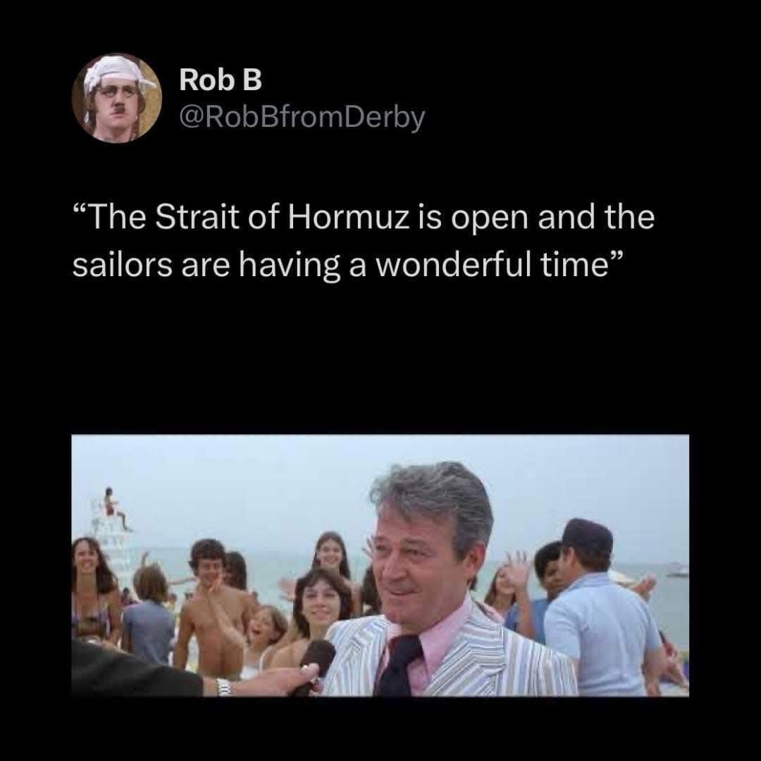 A satirical tweet from Rob B featuring a screenshot of the mayor from Jaws standing on a crowded beach. The caption ironically claims the Strait of Hormuz is open and safe for sailors, mirroring the character's refusal to acknowledge danger.