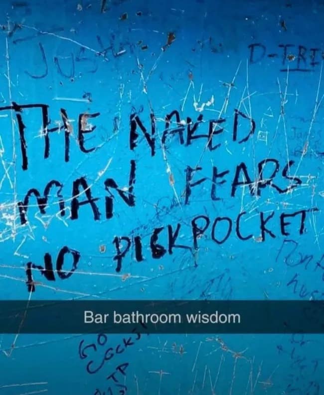 This hilarious meme capturing bar bathroom wisdom features a blue-painted stall wall covered in scratches and layers of graffiti. The main text, written in thick black marker, philosophically declares that the naked man fears no pickpocket