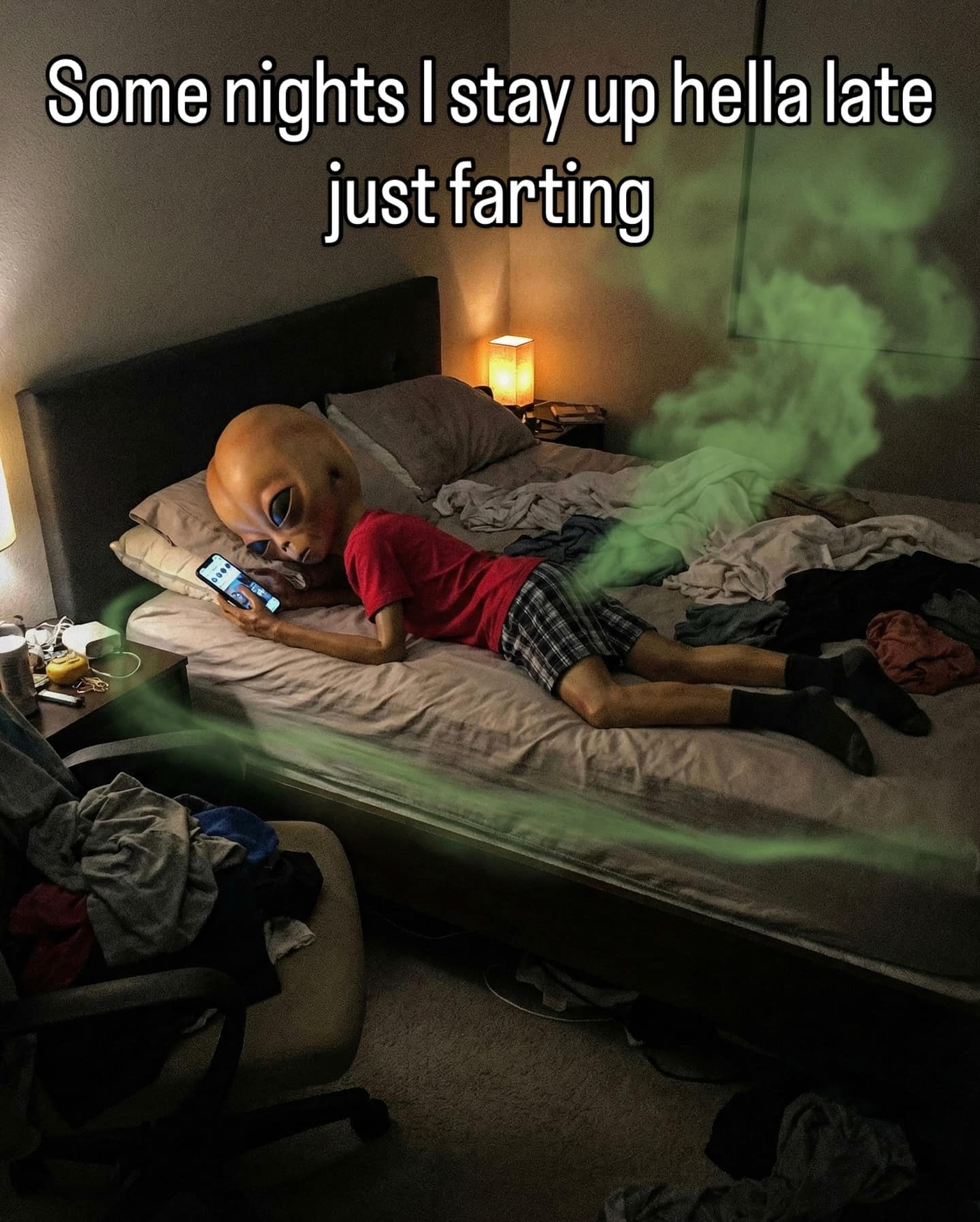 A relatable yet gross funny meme showing an alien figure lying on its stomach in bed, scrolling on a smartphone. A massive green cloud of gas is edited coming from the alien, with the top text: "Some nights I stay up hella late just farting."