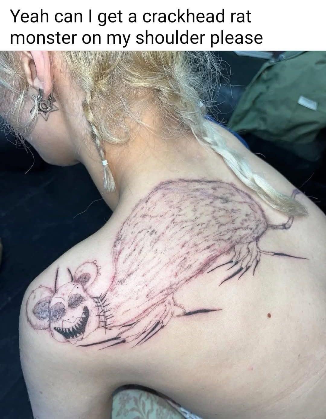 A shoulder tattoo of an intentionally mangy, terrifying rat with sharp teeth and wide eyes. This hilarious meme includes the caption, "Yeah can I get a crackhead rat monster on my shoulder please."
