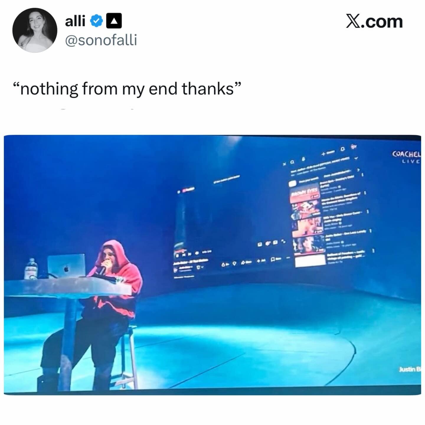 A workplace-themed funny meme featuring a photo of Justin Bieber’s minimalist 2026 Coachella stage, which looks exactly like a desk. He is sitting at a laptop with a massive YouTube playlist projected behind him. The caption from @sonofalli reads: "nothing from my end thanks."