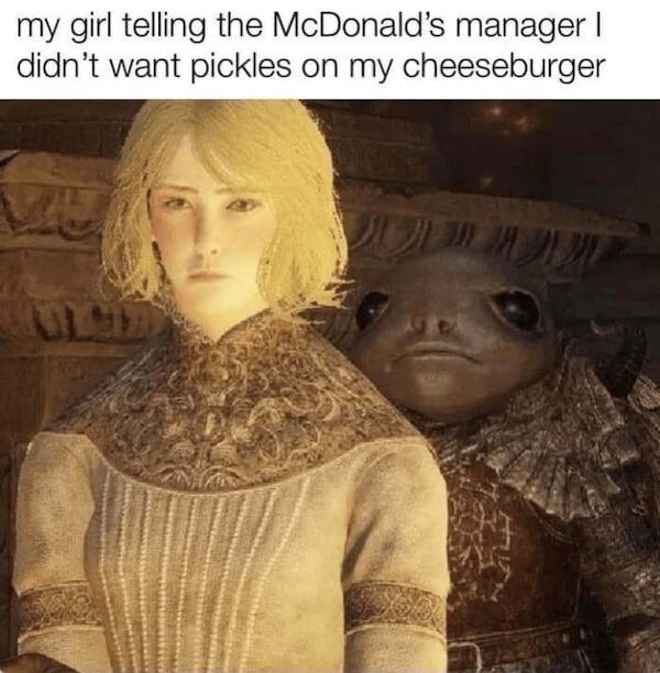 A hilarious meme using an Elden Ring screenshot. It shows the delicate character Roderika standing in front of a giant, bug-eyed Albinuric. The caption reads: "my girl telling the McDonald’s manager I didn’t want pickles on my cheeseburger."