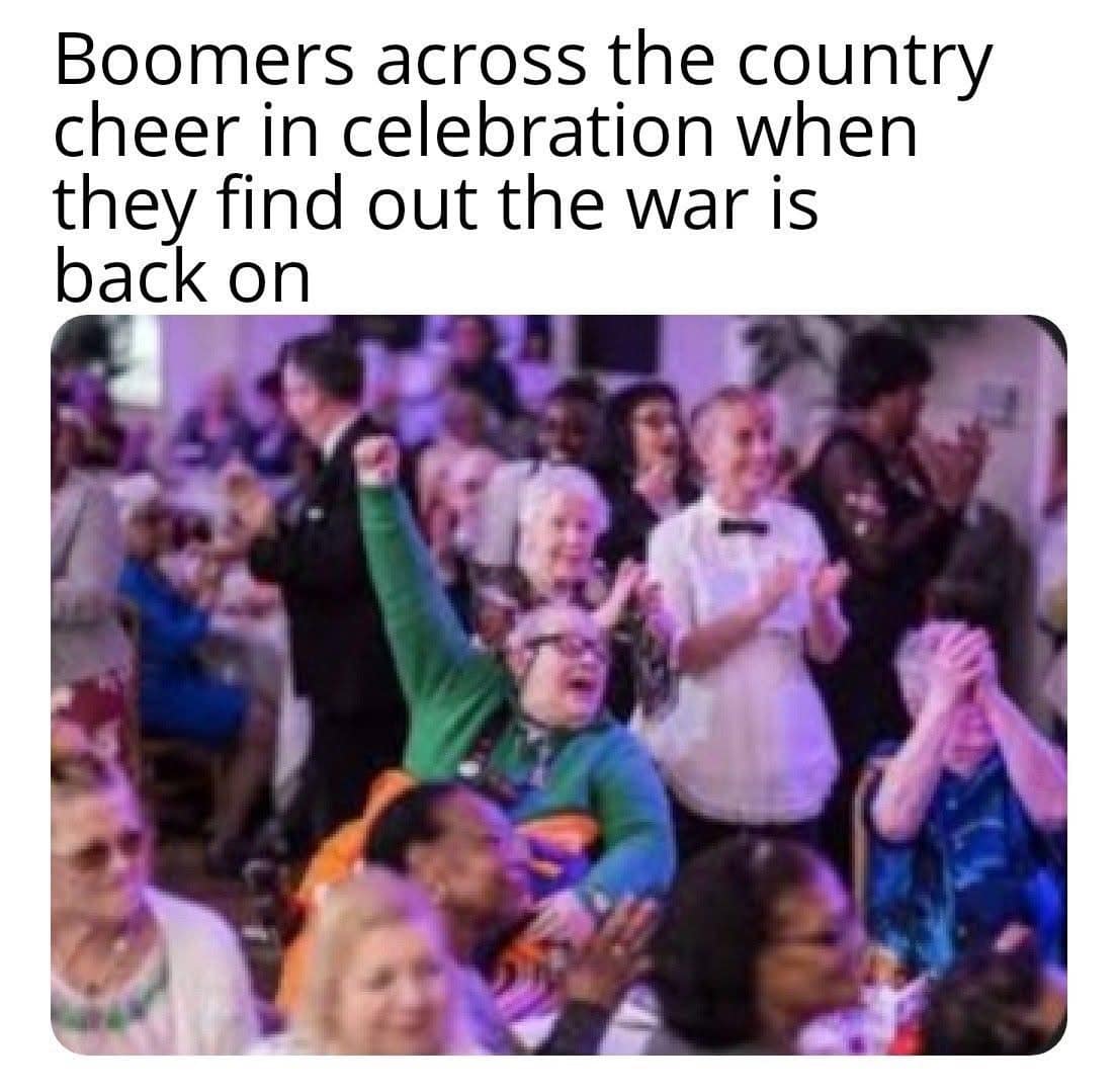 A cynical hilarious meme featuring a blurry photo of a crowd of senior citizens cheering and clapping in a purple-lit hall. The dark humor caption reads: "Boomers across the country cheer in celebration when they find out the war is back on."