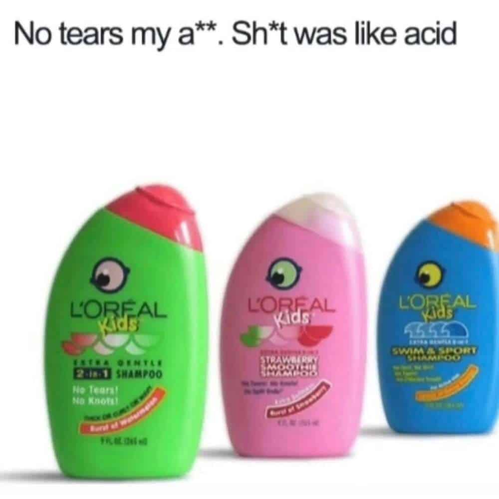 Three neon-colored bottles of L'Oreal Kids shampoo—including the "No Tears" watermelon and strawberry variants—are shown in this millennial meme. The text aggressively disputes the marketing claim, stating that the formula felt like actual "acid" when it inevitably hit your eyes.