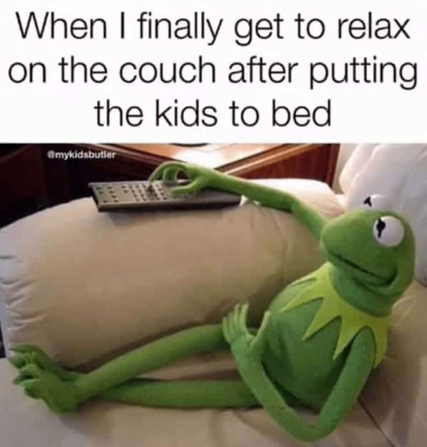 Kermit the Frog lounging on couch with remote captioned finally relaxing after putting kids to bed