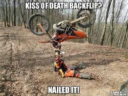 self-deprecating motorcycle meme showing a dirt bike rider who has crashed and is lying in a heap on the ground. The caption sarcastically asks: "KISS OF DEATH BACKFLIP? NAILED IT!", poking fun at failed stunts.