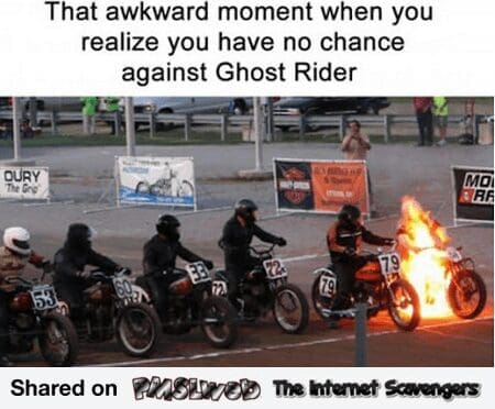 motorcycle meme showing a line of racers at a starting gate. While most riders look standard, one is completely engulfed in bright orange flames, bike and all. The caption reads: "That awkward moment when you realize you have no chance against Ghost Rider."