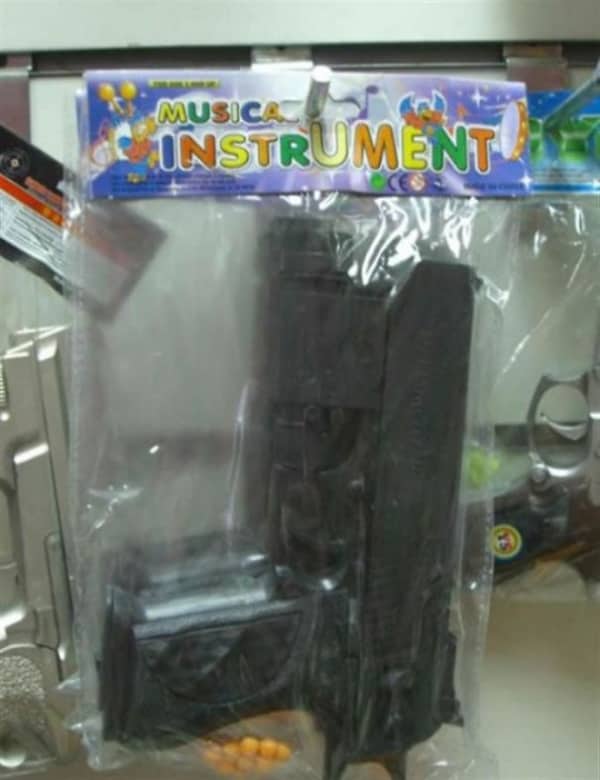 Plastic toy gun packaged and labeled as a musical instrument in colorful children's toy packaging fail