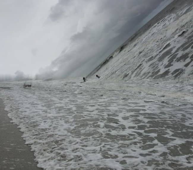A shoreline panorama fail where the ocean appears as a giant, steep vertical wall.