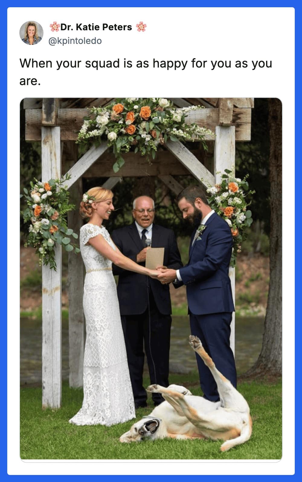 A chaotic dog meme featuring a beautiful outdoor wedding ceremony. As the bride and groom hold hands under a floral arch, their white dog is captured mid-celebration, rolling wildly on its back in the grass at their feet.