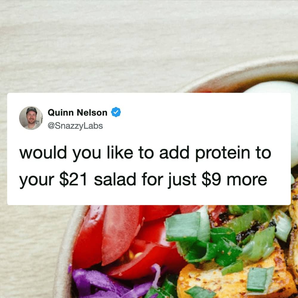 A tweet joking about the high cost of adding protein to an expensive salad.