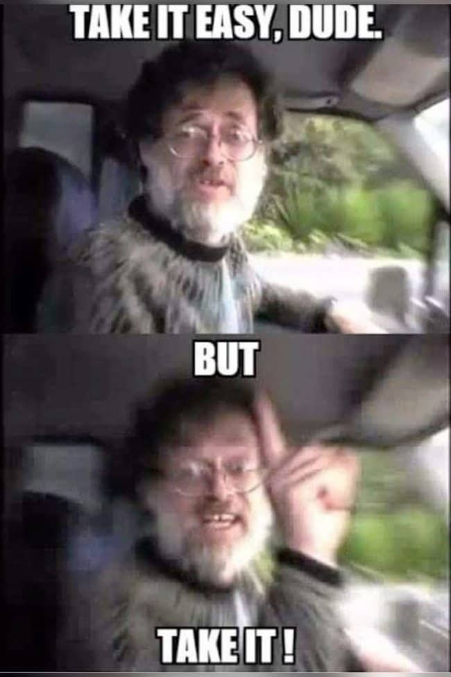 Terence McKenna in a car with a meme about taking it easy, but taking it.