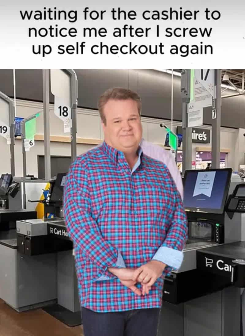 Eric Stonestreet smiling awkwardly at self-checkout waiting for an employee to come fix his mistake.
