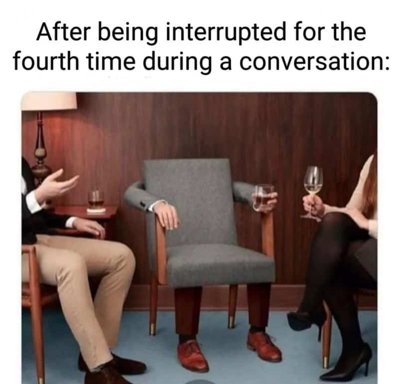 A grey armchair wearing a suit jacket and dress shoes sits dejectedly in a relatable meme about social awkwardness. It represents the feeling of effectively becoming an inanimate object after being repeatedly interrupted during a conversation.