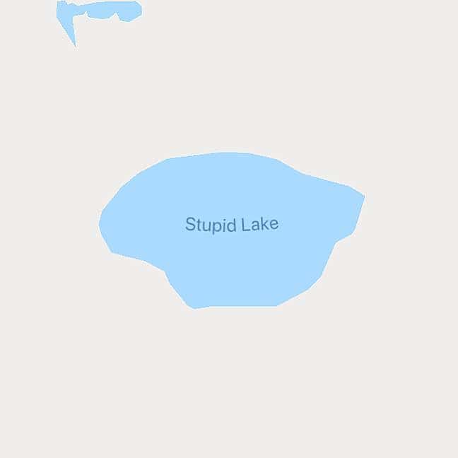 Map displaying rounded blue lake plainly labeled Stupid Lake against a beige terrain backdrop.