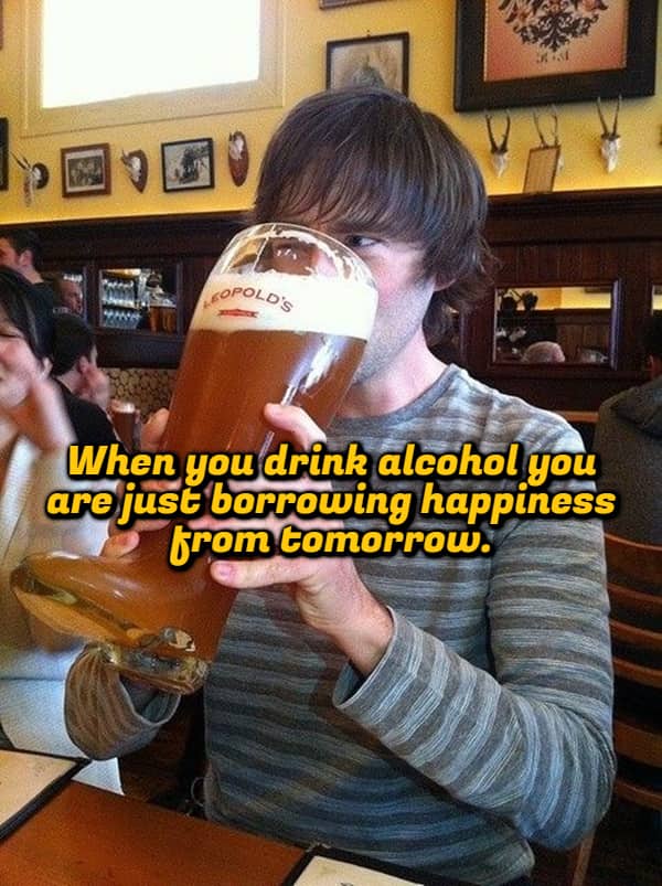 Man drinking from a giant glass boot with a deep shower thought about alcohol.