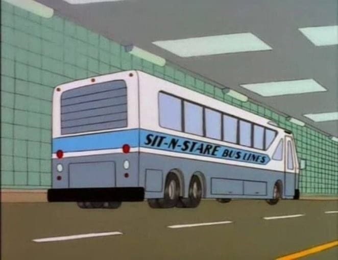 Simpsons animated bus driving through tunnel with "Sit-N-Stare Bus Lines" printed on the side