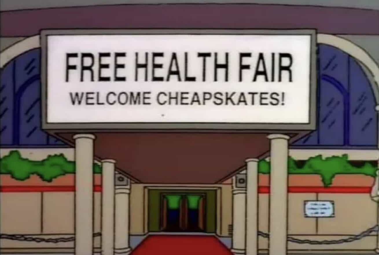 Simpsons Free Health Fair building entrance banner reading "Welcome Cheapskates" funny sign screenshot