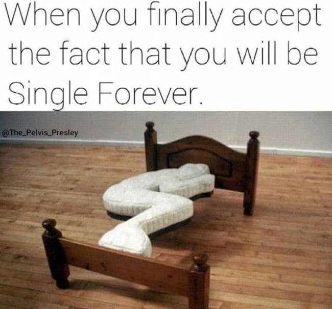 single life meme featuring a custom-shaped mattress on a wooden bed frame. The mattress is carved into a permanent, tight "L" or fetal position, representing the absolute acceptance of a life spent sleeping alone in a tiny, designated spot.