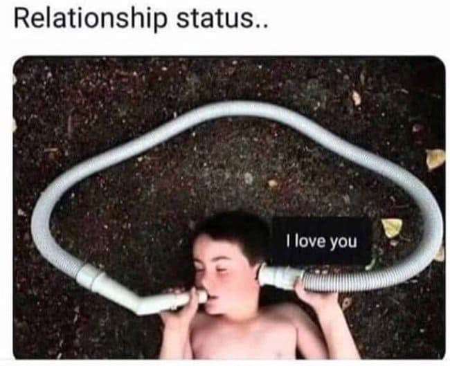 A "forever alone" style single meme of a young boy lying on the ground with a vacuum hose connecting his mouth to his own ear. A text bubble reads "I love you," illustrating a relationship status that is entirely self-contained and solitary.