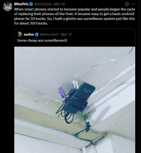 technology meme showing a budget surveillance camera setup made of an old smartphone secured to a ceiling using tape and a purple loofah, with a tangled mess of USB charging cables running along the wall.