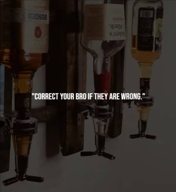 Three upside-down whiskey bottles mounted in a wooden wall dispenser rack, representing honest accountability between friends.