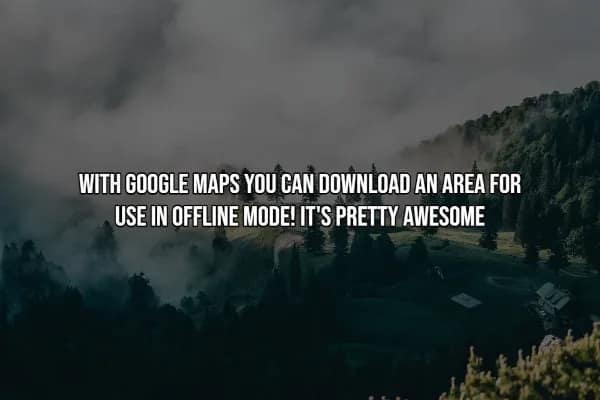 A travel hack recommending Google Maps offline mode for navigating without data. The text is displayed over a wide-angle shot of a misty, coniferous mountain range with clouds settled in the valley.