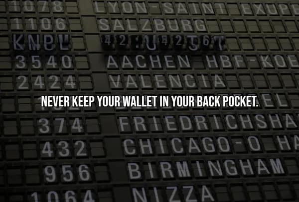 A travel hack warning against pickpockets by advising travelers to never keep their wallet in a back pocket. The text sits over a dark close-up of a vintage airport split-flap display board showing destinations like Salzburg and Valencia.