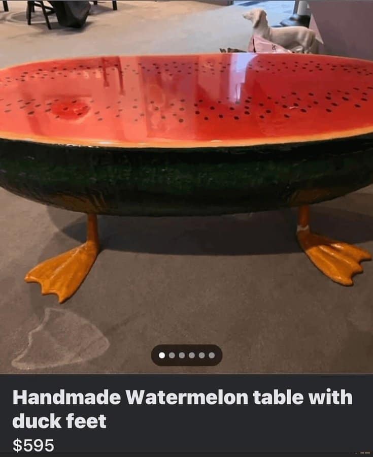 Handmade watermelon slice coffee table with bright yellow duck feet listed for 595 dollars