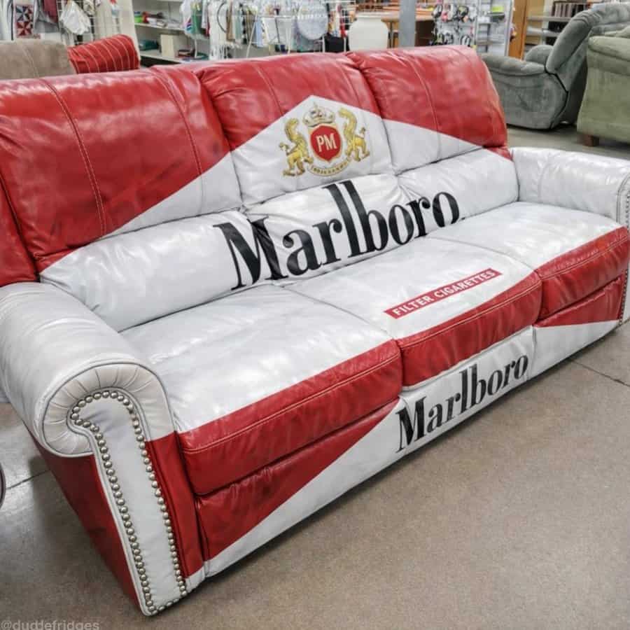 Full size leather sofa upholstered to look like a giant Marlboro cigarette pack in thrift store
