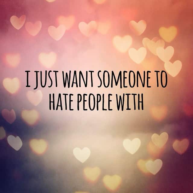 Pink bokeh heart background with cynical quote about wanting a partner to hate people with together.