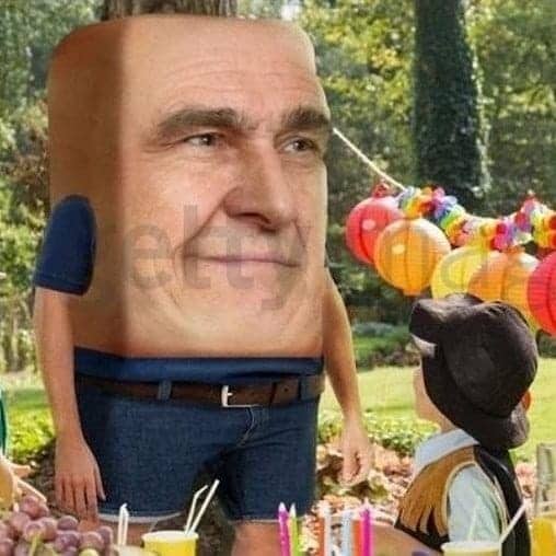 Surreal weird stock photo of man with oversized head attending outdoor children's birthday party