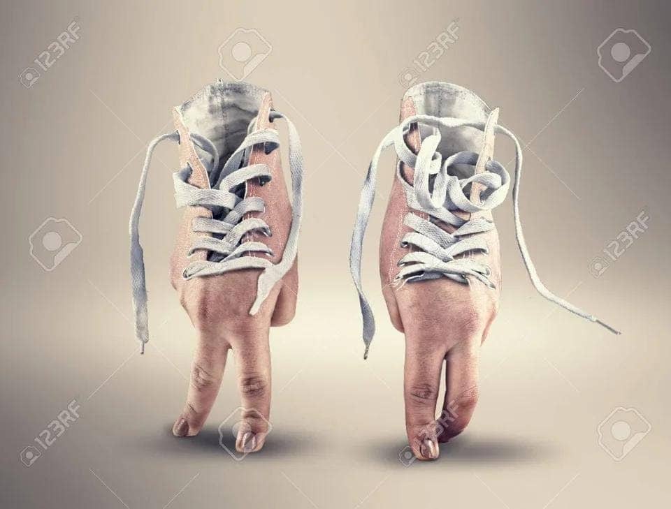 Surreal weird stock photo of sneakers with human toes poking out the bottom walking forward