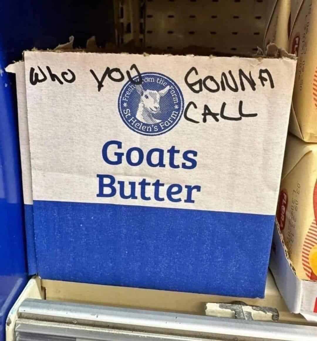 A grocery store shelf displaying a box of St Helen's Farm Goats Butter. In a classic example of wholesome vandalism, someone has used a black marker to write "WHO YOU GONNA CALL" above the label, creating a hilarious Ghostbusters pun.