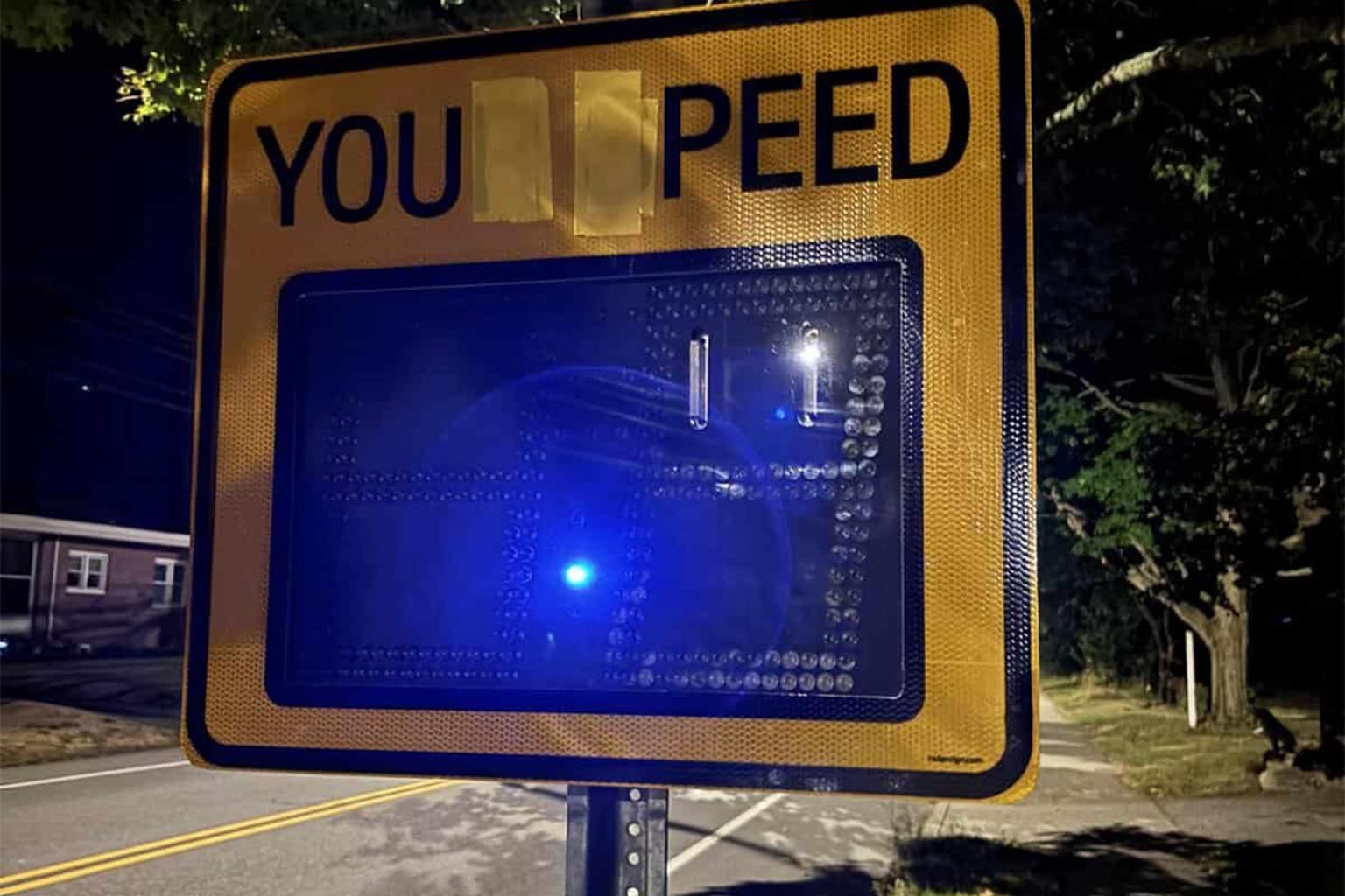 A collage of wholesome vandalism featuring a box of "Goats Butter" vandalized with a Ghostbusters pun, a yellow "wet floor" sign transformed into an "Alien abductions" warning with a paper UFO, and a sidewalk spray-painted with a "HAVE A NICE DAY" greeting.