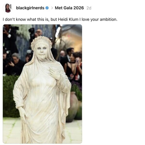 A 2026 Met Gala meme showcasing Heidi Klum’s ambitious look, where she is completely draped in heavy, off-white fabric to resemble a centuries-old marble statue.