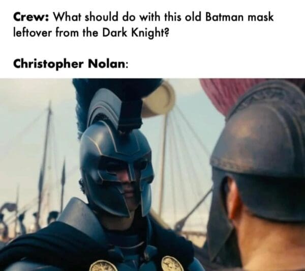A hilarious Nolan's Odyssey meme comparing a modern, matte-black Greek hoplite helmet to an "old Batman mask leftover from the Dark Knight," poking fun at Nolan's obsession with tactical, grounded aesthetics.