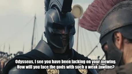 A Nolan's Odyssey meme showing a Spartan soldier in a matte black helmet with a sub-caption mocking Odysseus for "lacking on his mewing" and having a "weak jawline" before facing the gods.